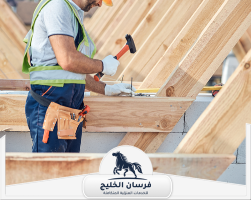 نجار مسلح في عجمان 0547761153 فرسان الخليج فني نجارة يعمل على تركيب هيكل خشبي باستخدام المسامير والمطرقة.