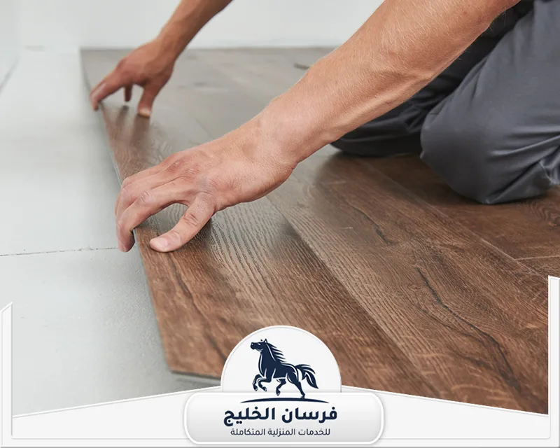 تركيب سيراميك باركيه في دبي - فرسان الخليج فني باركيه يعمل على تركيب الألواح الخشبية وضبط استقامتها أثناء التنفيذ.